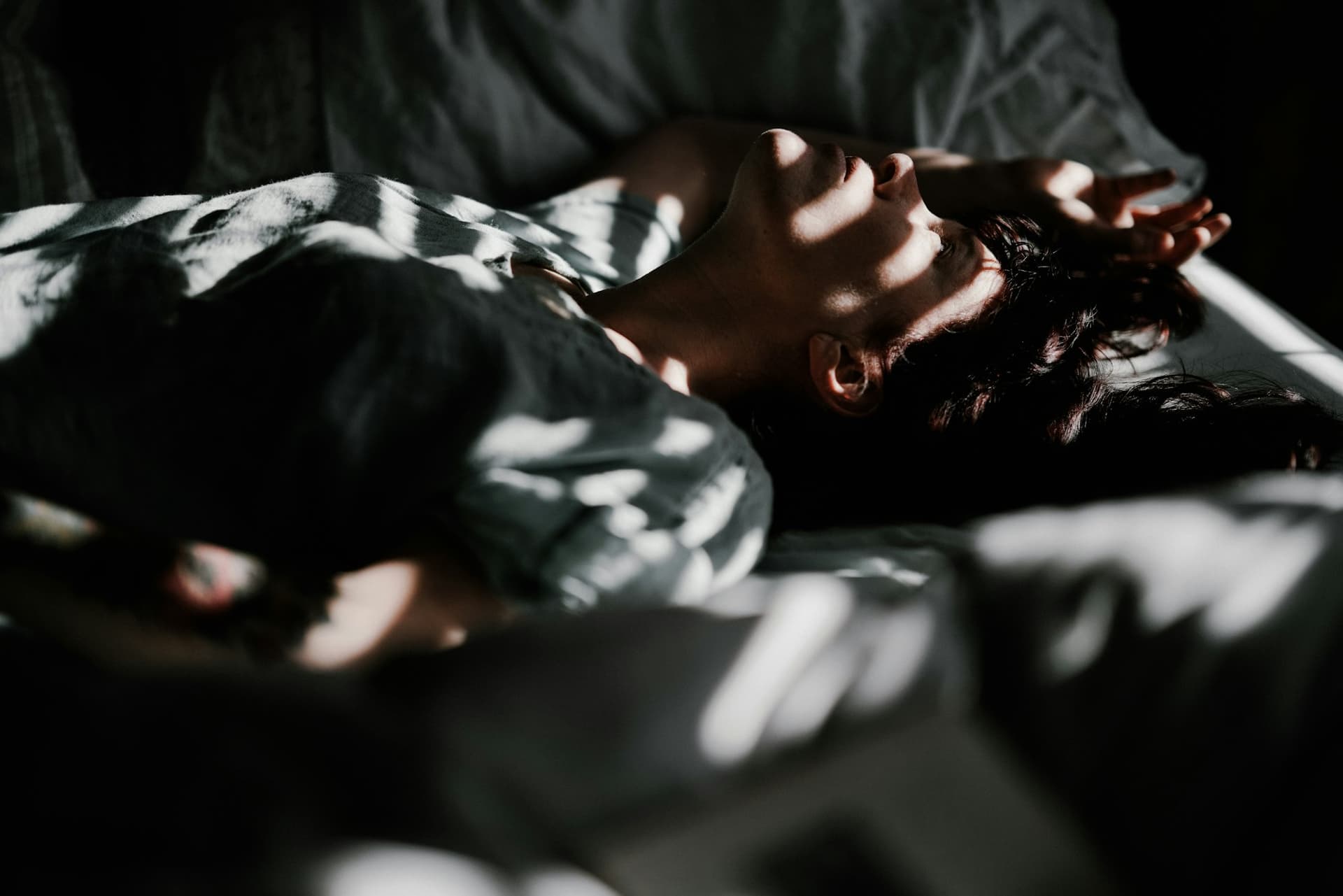 A person asleep at dawn with soft light